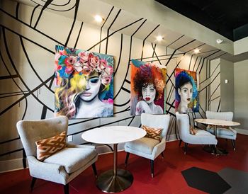 Collaboration room with art on the wall and chairs with a table in front of them at the Collective NoDA Charlotte NC